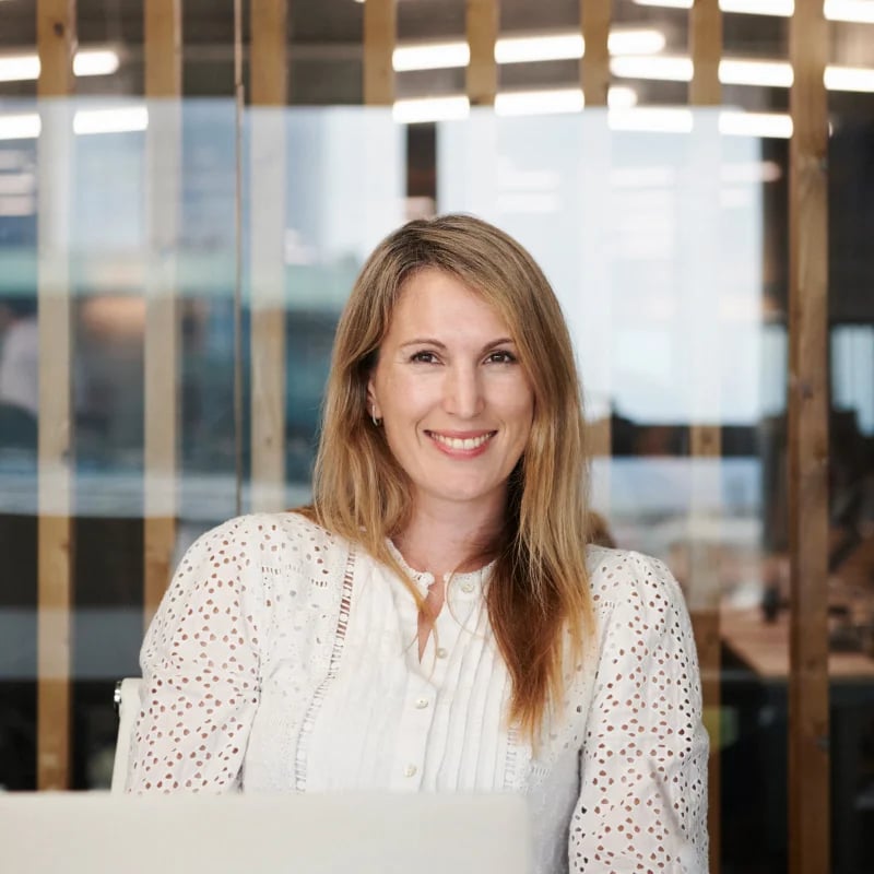 hr workflows female employee smiling facing camera