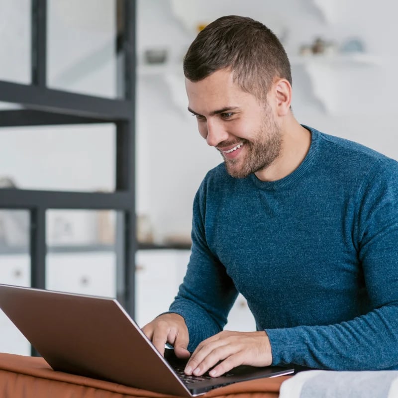 run control smiling male looking at laptop