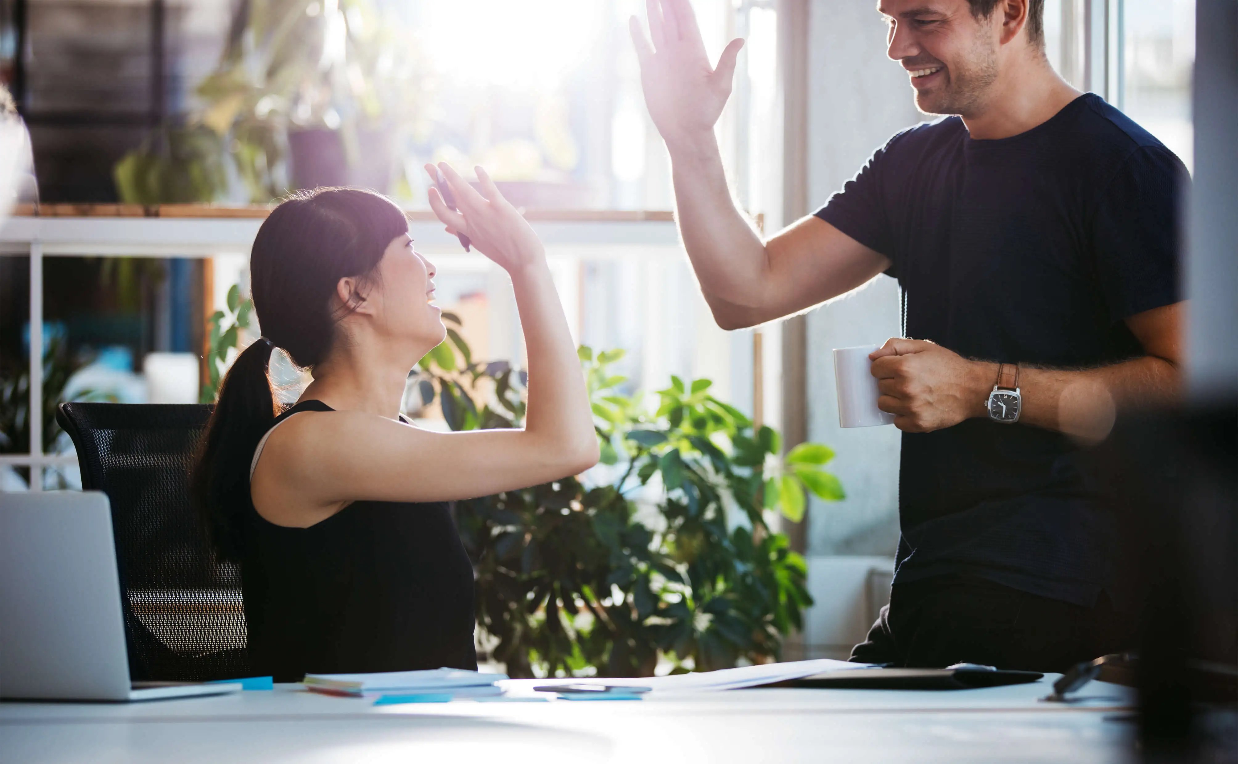 Two people high fiving